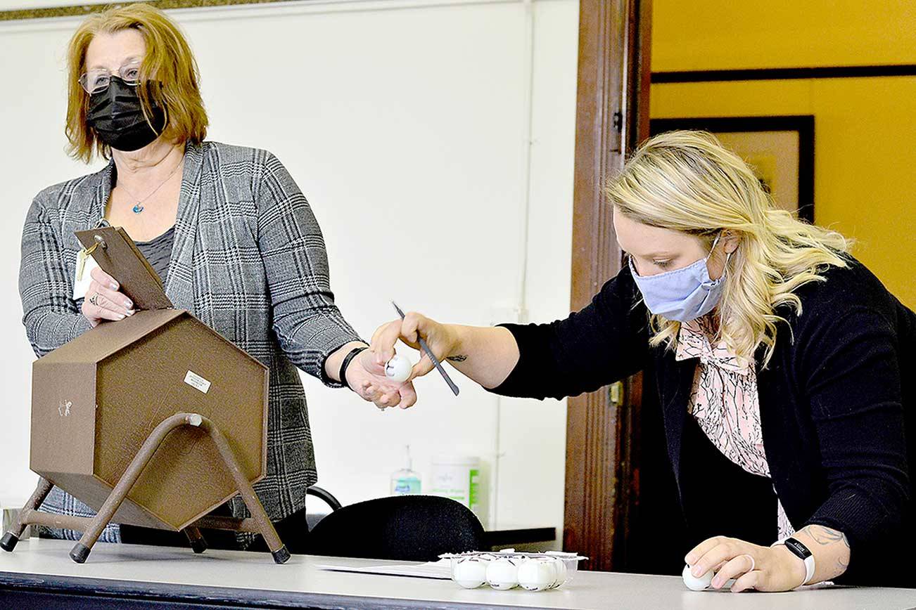 Jefferson County Auditor Rose Ann Carroll, left, and Election Coordinator Quinn Grewell used golf balls Monday morning at the Jefferson County Courthouse to conduct the lot draw for the order of candidates’ name on the primary election ballot. The Aug. 3 election includes hopefuls for Port Townsend City Council, Port Ludlow Fire District No. 3, Sequim School Board and Clallam County Fire District No. 3, which includes a portion of East Jefferson County. (Diane Urbani de la Paz/Peninsula Daily News)