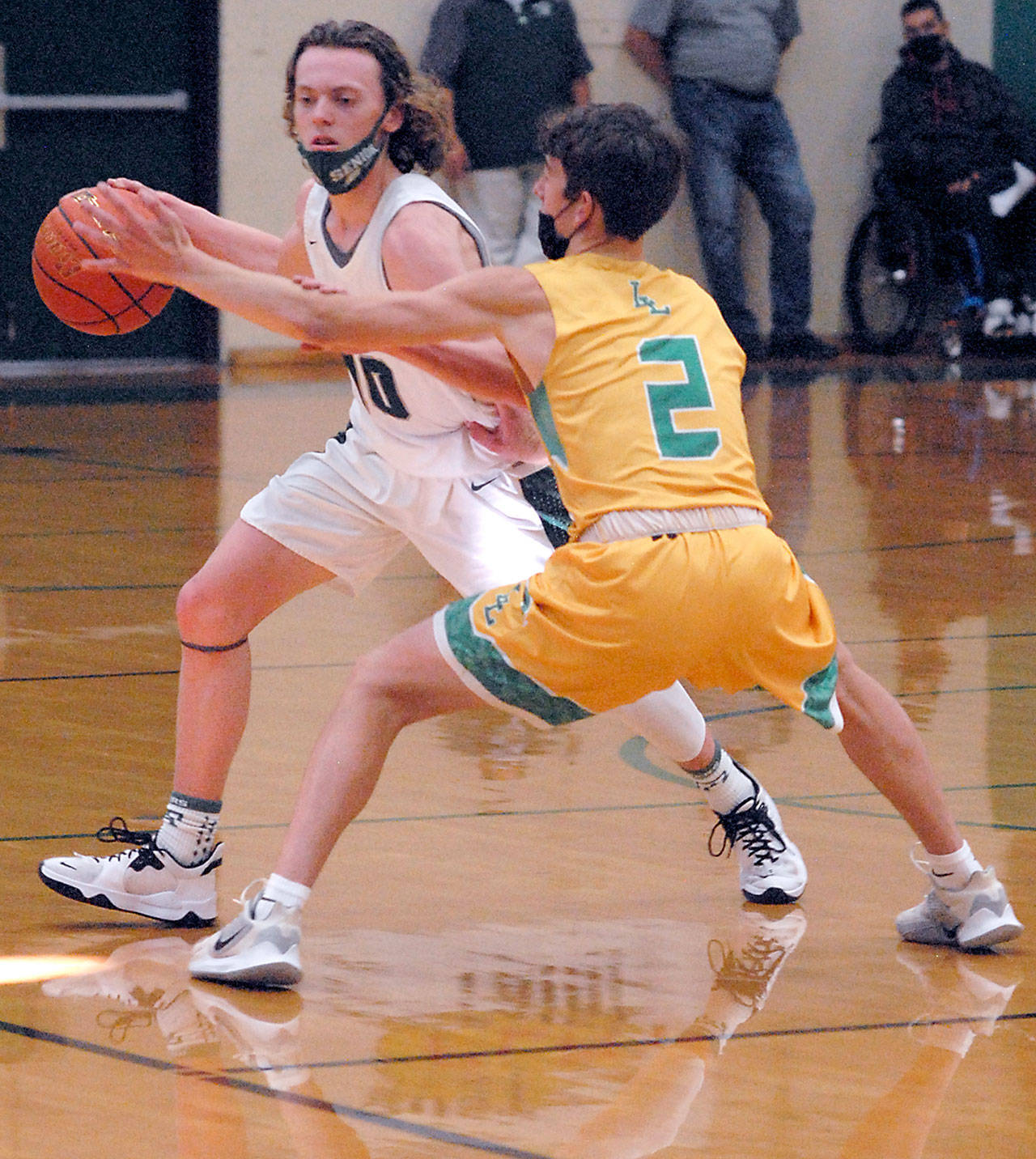 Keith Thorpe/Peninsula Daily News Port Angeles’ Dru Clark, left, tries to evade Lynden’s Coston Parcher on Friday night in Port Angeles.