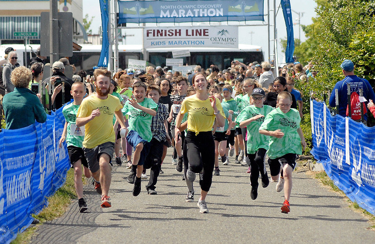 Youngsters accompanied by a pair of pace runners take off down the Waterfront Trail portion of the Olympic Discovery Trail from Port Angeles City Pier during the 2019 North Olympic Discovery Marathon Kids’ Marathon. (Keith Thorpe/Peninsula Daily News)