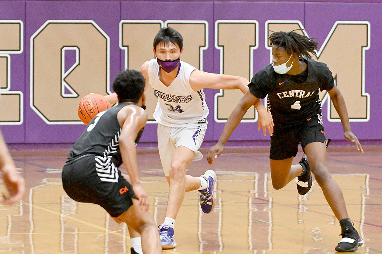Michael Dashiell/Olympic Peninsula News Group

Sequim's Isaiah Moore dribbles between two Central Kitsap defenders during the Wolves' 72-49 loss Wednesday. Moore had 19 points and eight rebounds to lead Sequim.