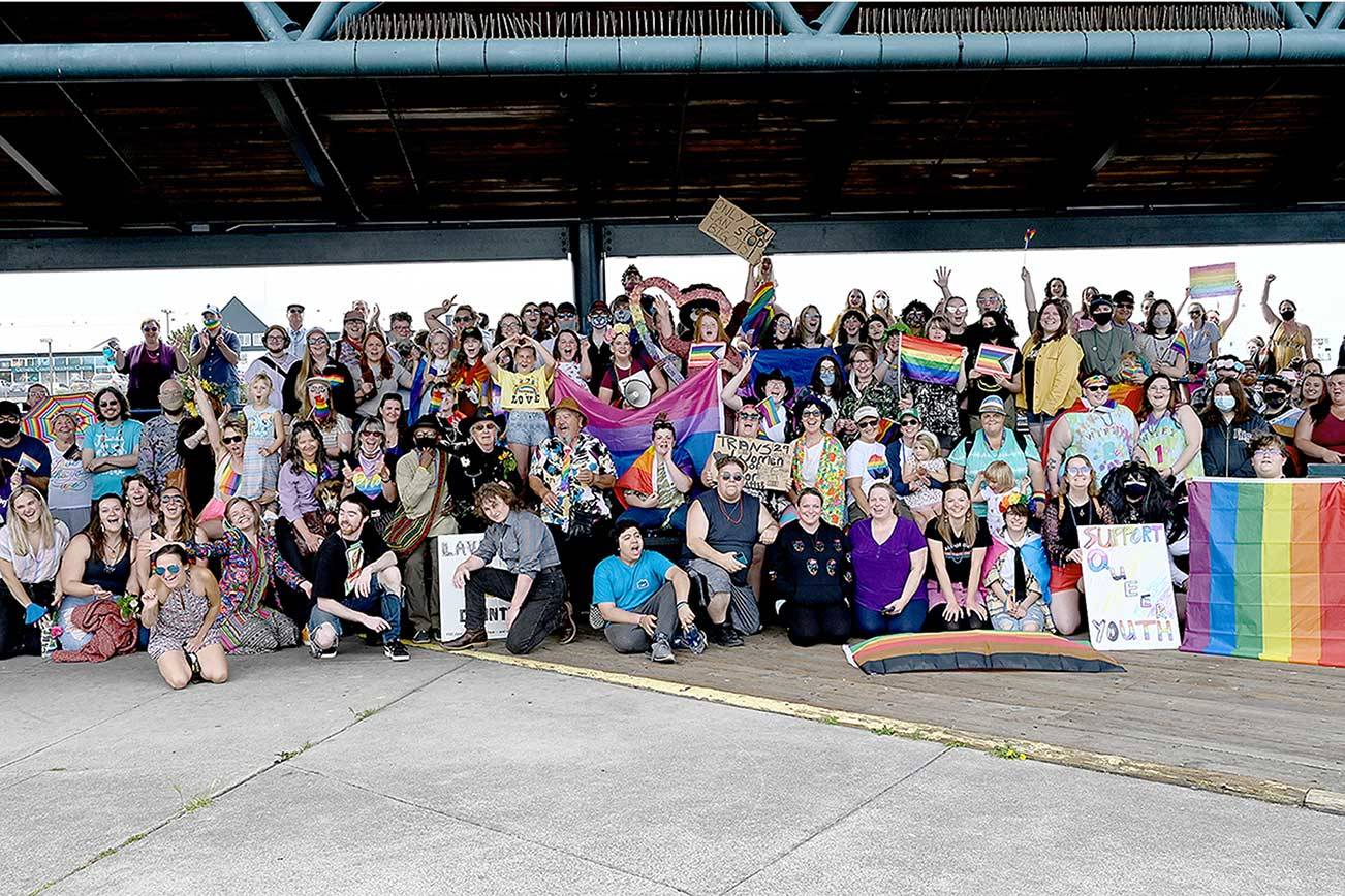 About 370 people gather Saturday at City Pier in Port Angeles for the inaugural Pride Celebration. Separate marches from the pier and the Clallam County Courthouse converged at Front and Lincoln streets led by Eli Smith and Ian Nickel. Earlier in the day, the Farmers Market celebrated pride month and SisterLand Farms gave out free plant starts to anyone who visited in their best pride-themed outfit. Food Not Bombs had a free pride-themed barbecue at Jesse Webster Tree Park, and the North Olympic Library System hosted an online event called “Storytime with a Queen.” The event organizers were Navarra Carr, Cloud Huxley, Jenson, Benji Astrachan, Smith and Nickel. (Photo courtesy of Kasia Kawczynski)