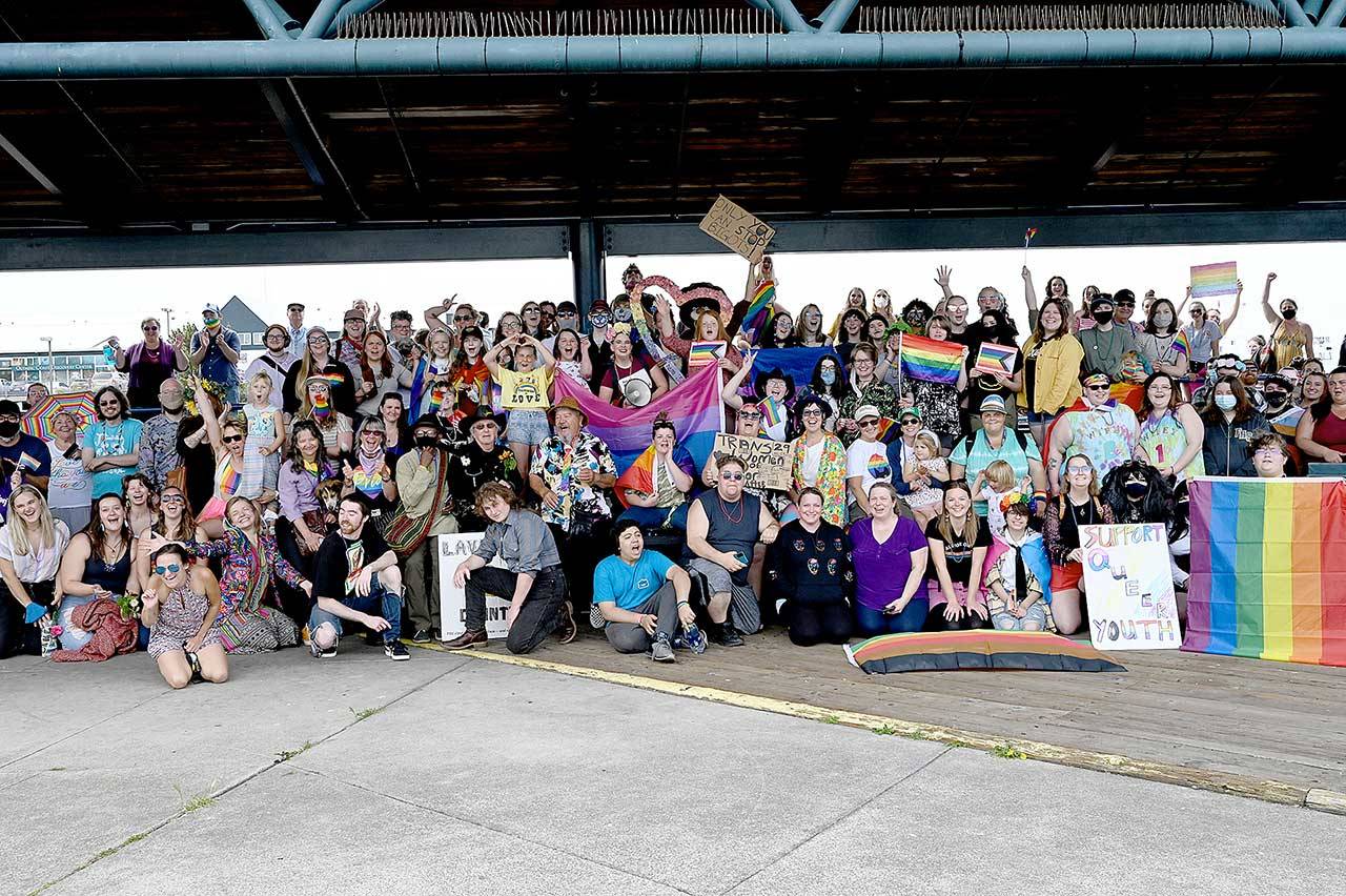 About 370 people gather Saturday at City Pier in Port Angeles for the inaugural Pride Celebration. Separate marches from the pier and the Clallam County Courthouse converged at Front and Lincoln streets led by Eli Smith and Ian Nickel. Earlier in the day, the Farmers Market celebrated pride month and SisterLand Farms gave out free plant starts to anyone who visited in their best pride-themed outfit. Food Not Bombs had a free pride-themed barbecue at Jesse Webster Tree Park, and the North Olympic Library System hosted an online event called “Storytime with a Queen.” The event organizers were Navarra Carr, Cloud Huxley, Jenson, Benji Astrachan, Smith and Nickel. (Photo courtesy of Kasia Kawczynski)