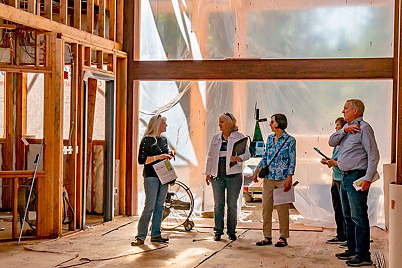 Lyn Muench, grant writer for the Dungeness River Audubon Center’s “Inspire Wonder” capital campaign, shows Rep. Steve Tharinger details of River Center construction. Photo by Margi Palmer