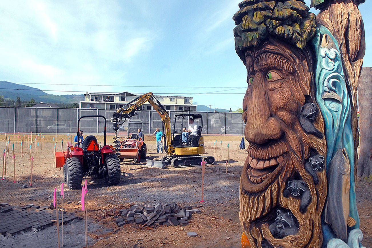 Keith Thorpe/Peninsula Daily News
Volunteers bore holes and prepare the site on Friday for the beginning of a community build of the Generation II Dream Playground, scheduled to begin on Tuesday, at Erickson Playfield in Port Angeles.