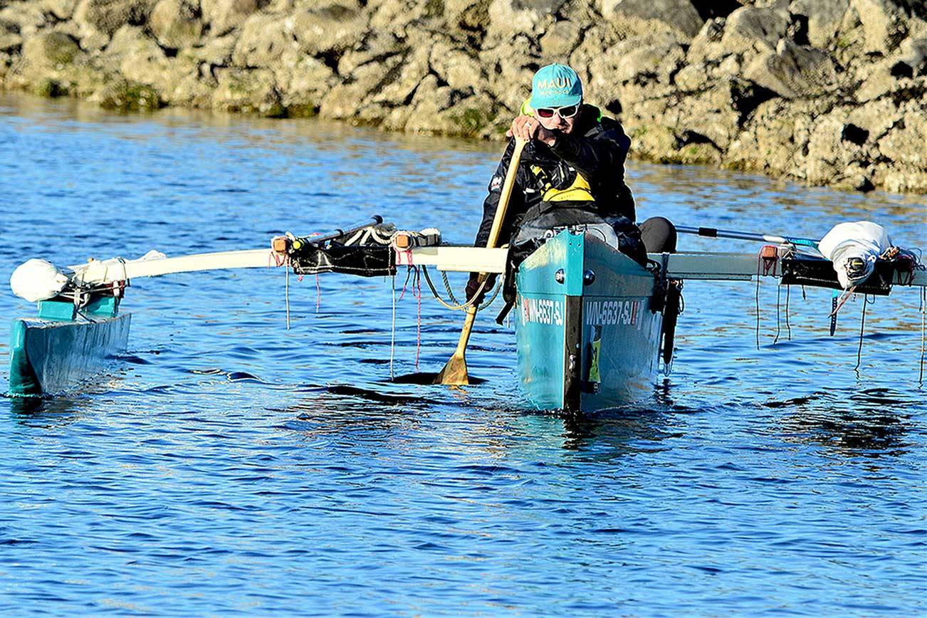 After 12 days touring Puget Sound, Andy Jacobs paddles his trimaran into the Port Townsend Boat Haven on Saturday night. (Diane Urbani de la Paz/Peninsula Daily News)