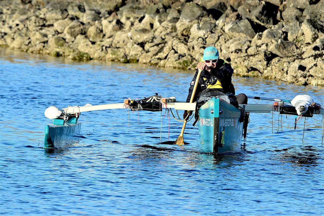 After 12 days touring Puget Sound, Andy Jacobs paddles his trimaran into the Port Townsend Boat Haven on Saturday night. (Diane Urbani de la Paz/Peninsula Daily News)