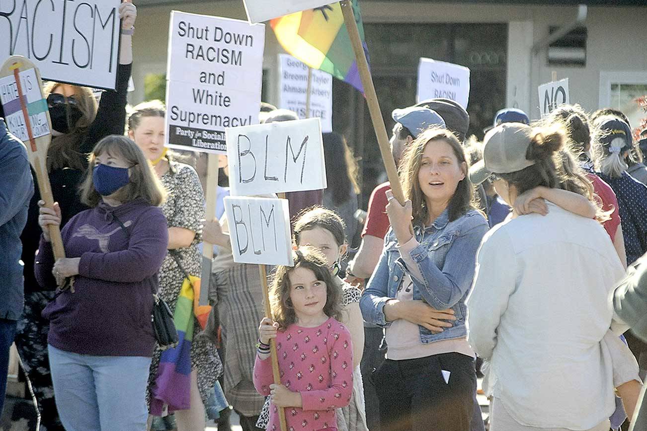 Mariia Bush stands with her two daughters, Madison, 9, and Avery, 6, during the Juneteenth Protest Against Racism and Hate on Saturday in downtown Sequim. (Matthew Nash/Olympic Peninsula News Group)