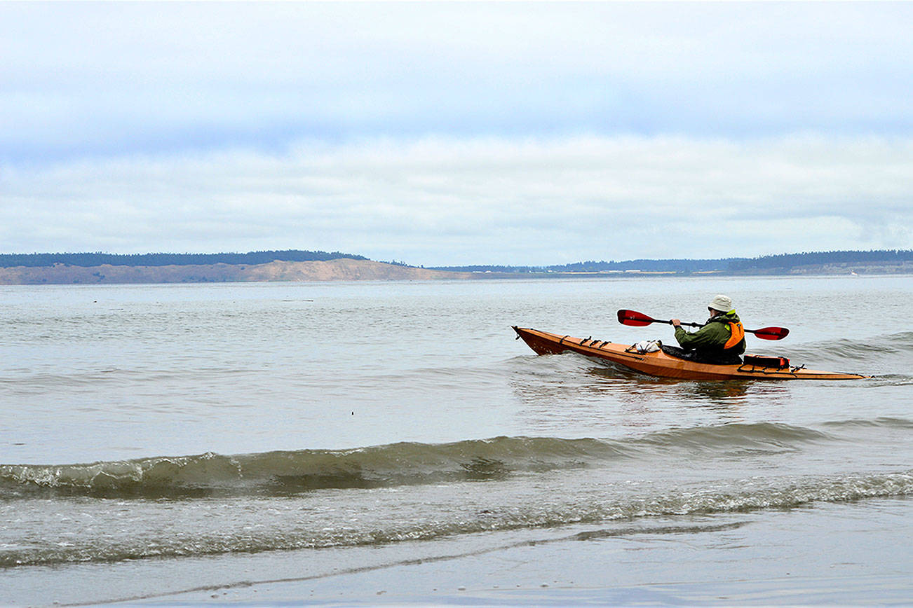 Roy Walker of Port Townsend stays close to shore as he launches his kayak from North Beach County Park on Wednesday morning. Hugging the shore and staying mindful of wind and weather changes are crucial, emergency responders say. Diane Urbani de la Paz/Peninsula Daily News