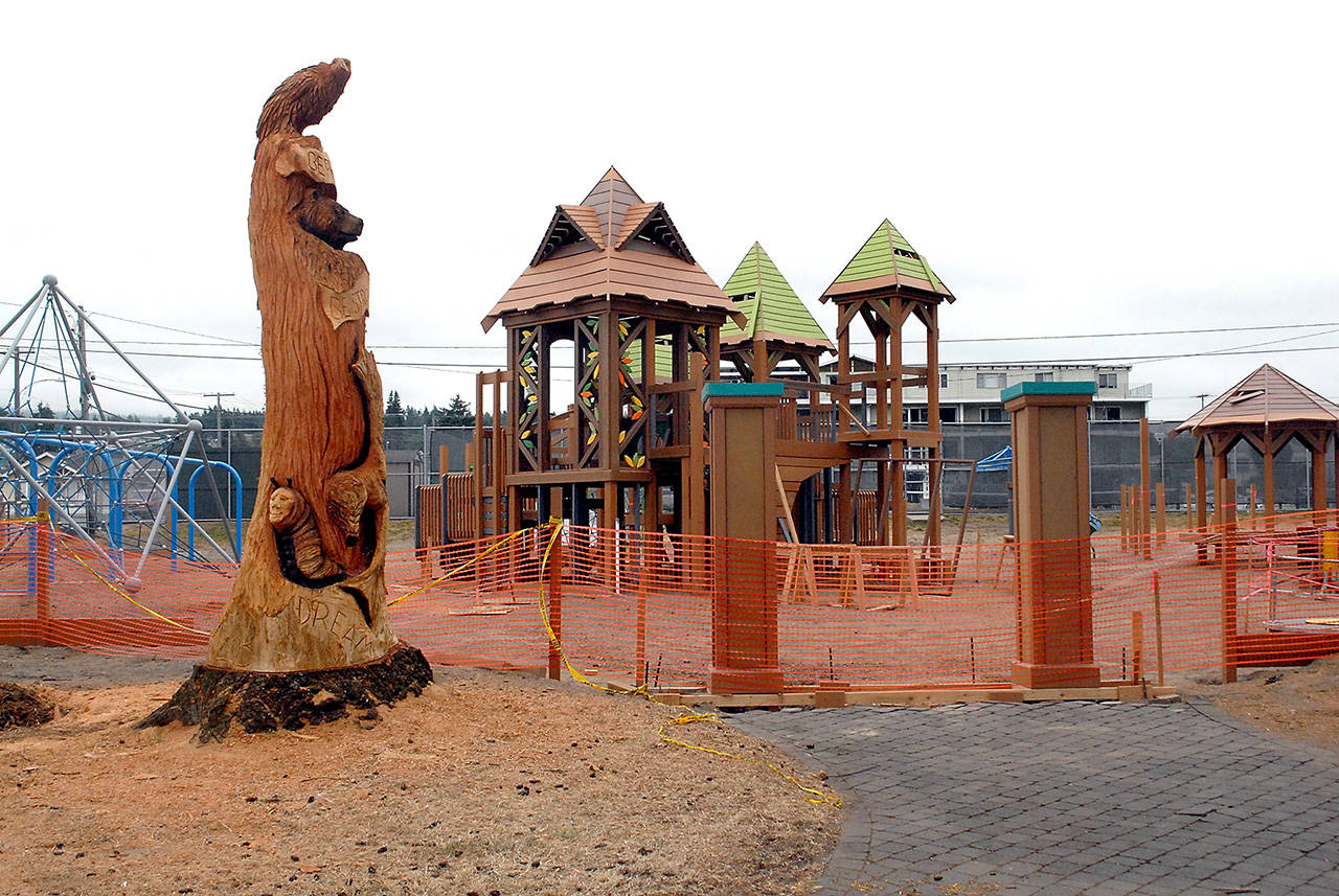 Safety fencing surrounds portions of the idled Generation II Dream Playground on Wednesday at Erickson Playfield in Port Angeles. (Keith Thorpe/Peninsula Daily News)