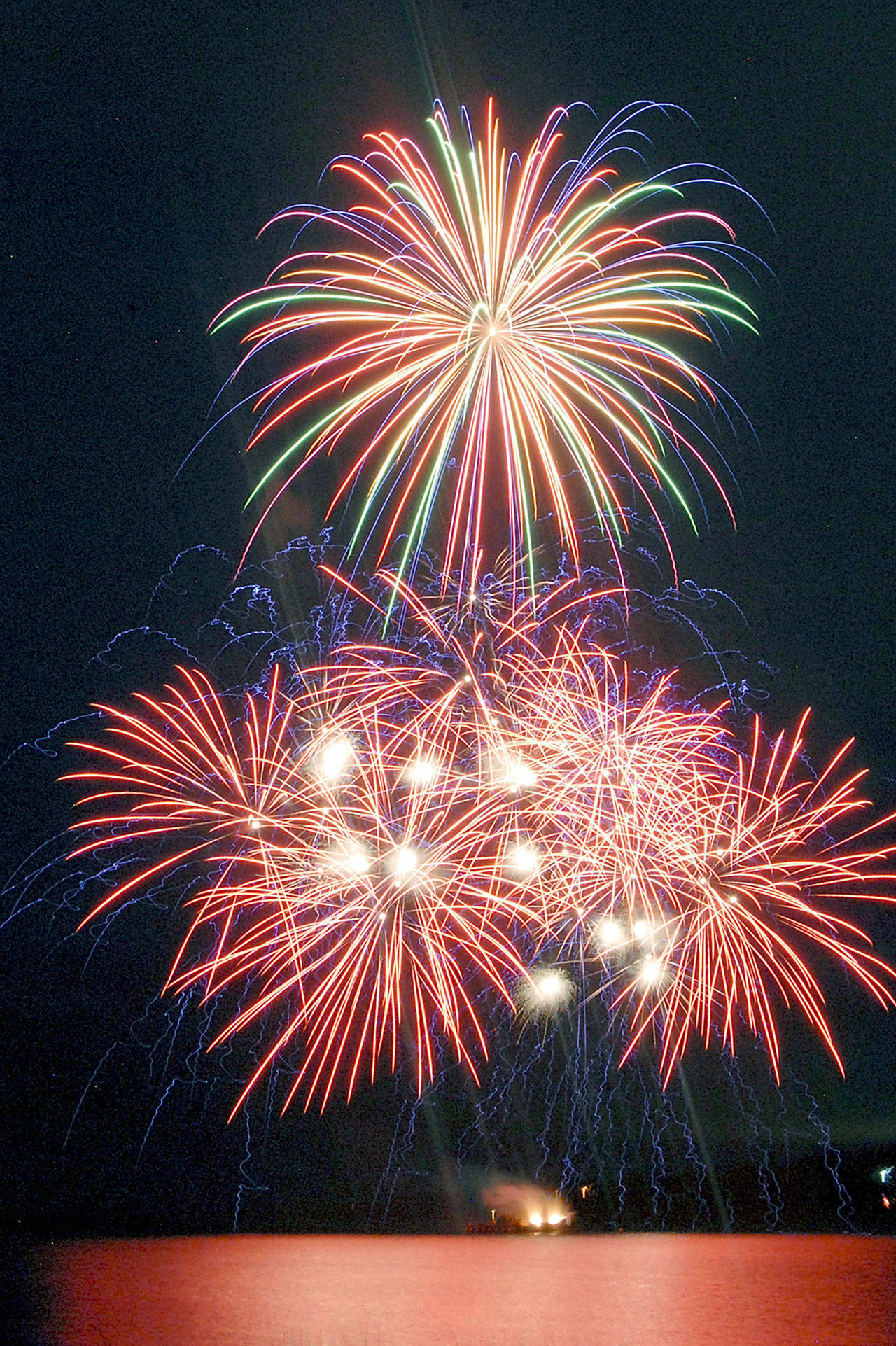Bursts of fireworks light up the sky over Port Angeles Harbor during the 2019 Independence Day display. (Keith Thorpe/Peninsula Daily News)