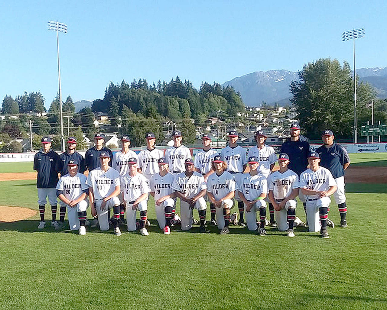 The Wilder Senior baseball club receives its championship trophy Sunday night at Civic Field after beating the Riverdogs 10-0 in the title game. Wilder went 6-0 in the Dick Brown Memorial Firecracker Classic. (Pierre LaBossiere/Peninsula Daily News)