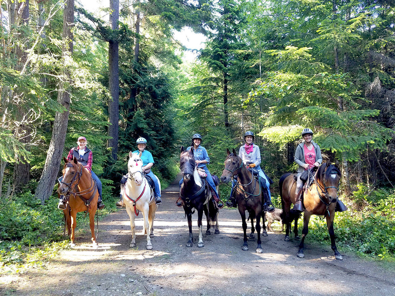 Backcountry Horseman Peninsula Chapter members Judy Dupree, left, and Linda Morin host guest riders from the Olympic Riders and Scattercreek chapters of BCH on a 12-mile ride through Miller Peninsula State Park (Photo courtesy of Linda Morin)