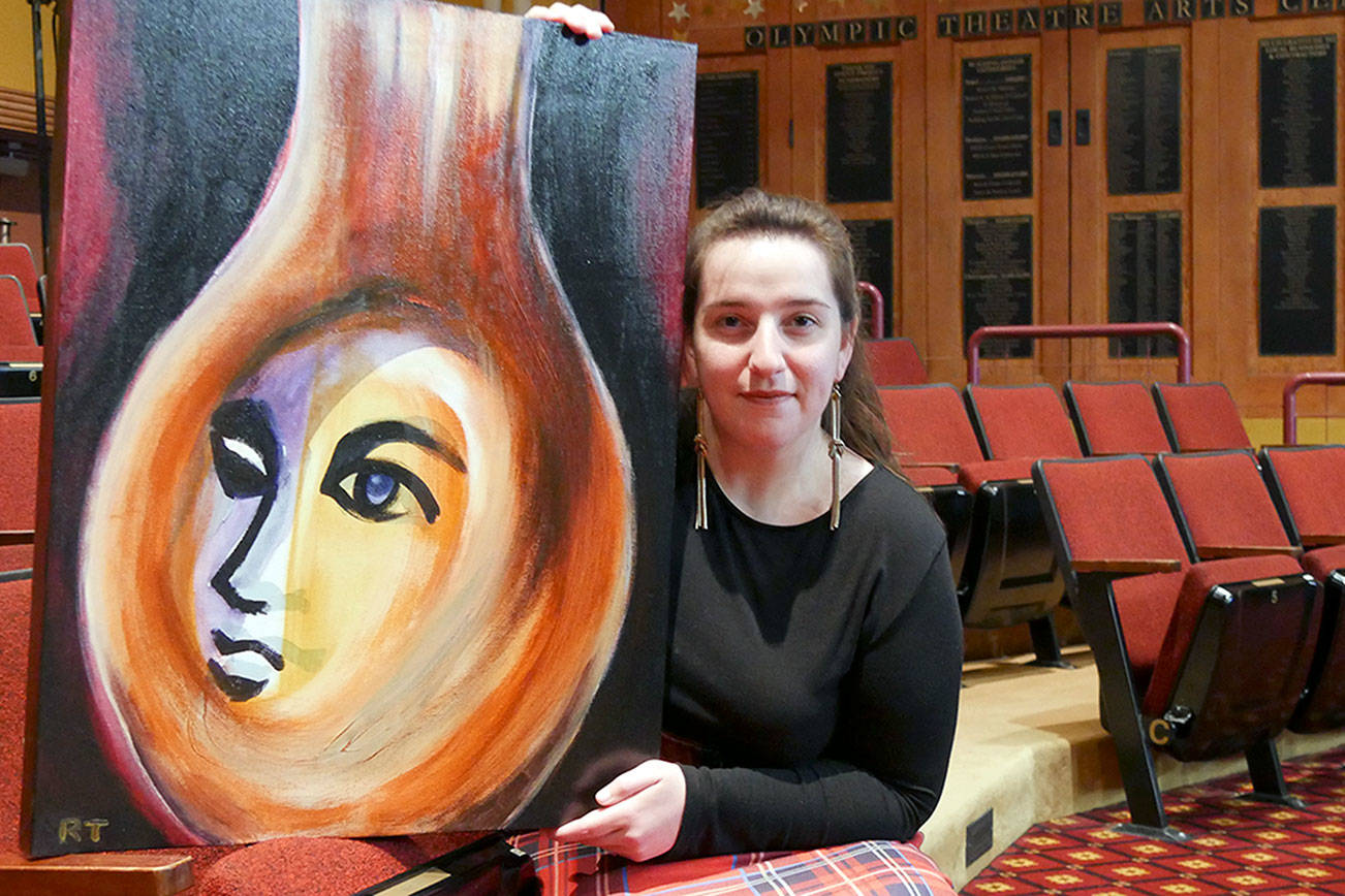 Interim Executive Director Ginny Holladay holds artwork for Angel Street, which was created and donated by Ryoko Toyama.