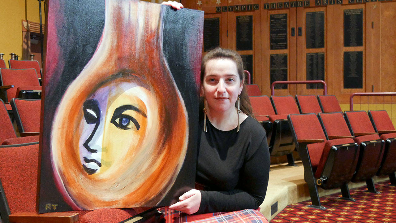 Interim Executive Director Ginny Holladay holds artwork for Angel Street, which was created and donated by Ryoko Toyama.