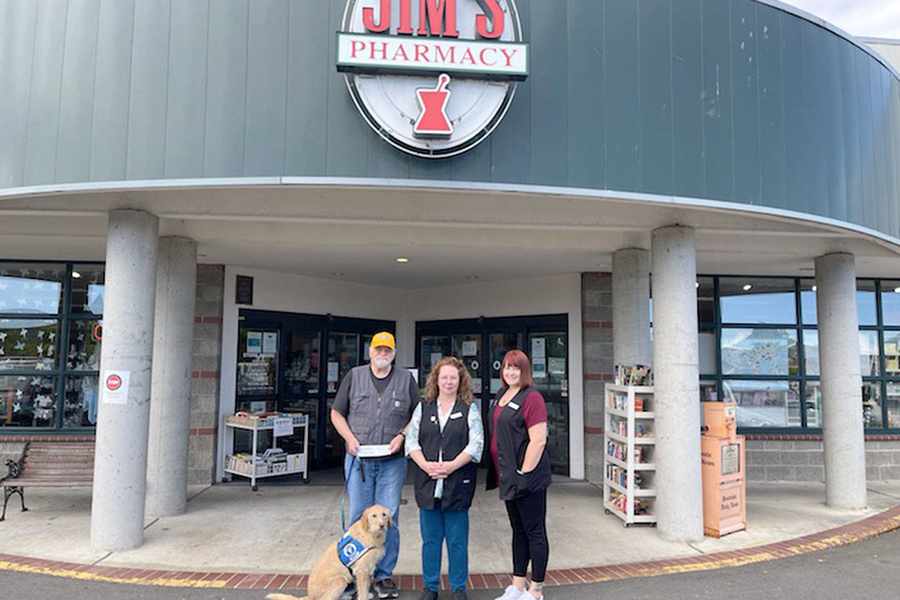 Staff and customers at Jim’s Pharmacy in Port Angeles raised $665 to support Voices for Veterans, the June recipient of Jim’s Cares Monthly Charity. The funds are raised through monetary donations, used book sales, donated employee casual days and a percentage of over-the-counter sales at Jim’s Pharmacy. John Braasch, left, of Voices for Veterans receive a check from Jim's Pharmacy employees Lori Ambrose and Jessica Thompson.