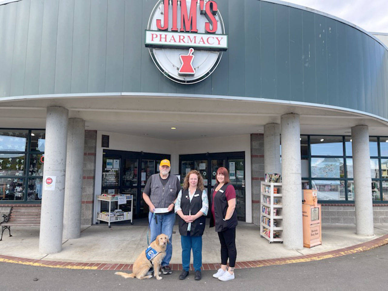 Staff and customers at Jim’s Pharmacy in Port Angeles raised $665 to support Voices for Veterans, the June recipient of Jim’s Cares Monthly Charity. The funds are raised through monetary donations, used book sales, donated employee casual days and a percentage of over-the-counter sales at Jim’s Pharmacy. John Braasch, left, of Voices for Veterans receive a check from Jim’s Pharmacy employees Lori Ambrose and Jessica Thompson.