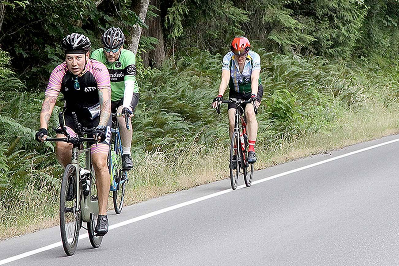 A large group of Ride the Hurricane bicyclists approach the Heart O’ the Hills near the beginning of the 17-mile trek up to 5,242 feet. About 800 riders participated in the event on Sunday with a round-trip ride to the top of Hurricane Ridge and back to Port Angeles. (Dave Logan/for Peninsula Daily News)