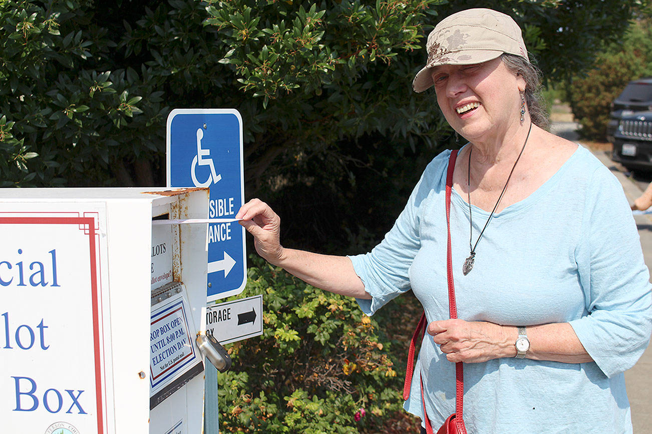 Kate Kinney of Port Townsend turns in her ballot from the primary election at the dropbox in front of the Jefferson County Courthouse on Tuesday afternoon. Results of Tuesday’s primary election are posted online at www.peninsuladailynews.com and will be explored in depth in Thursday’s print edition. (Zach Jablonski/Peninsula Daily News)