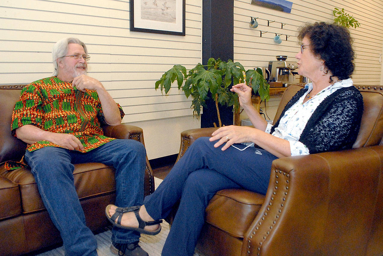 Keith Thorpe/Peninsula Daily News Doc Reiss, left, talks with Kathi Pressley in Port Angeles. Pressley will take over as the U.S. contact for the Dignity Toilets for Togo project that Reiss started while he is in African beginning an off-shoot business.