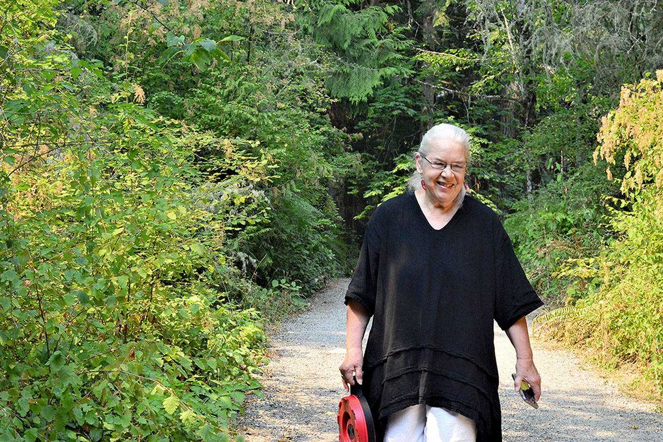 Artist Sara Mall Johani, pictured outside her workshop in Chimacum, will present her new book, "Mine, Yours, Nobody's: My Story of Wild Olympic Salmon," at the Jefferson Museum of Art & History this Saturday. (Diane Urbani de la Paz/Peninsula Daily News)