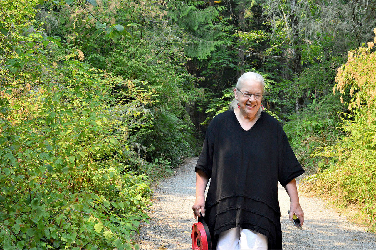 Artist Sara Mall Johani, pictured outside her workshop in Chimacum, will present her new book, “Mine, Yours, Nobody’s: My Story of Wild Olympic Salmon,” at the Jefferson Museum of Art & History this Saturday. (Diane Urbani de la Paz/Peninsula Daily News)
