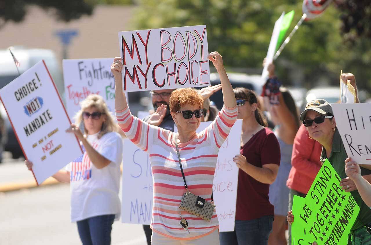 More than 100 protesters fill the corners of Washington Street and Sequim Avenue on Wednesday. (Michael Dashiell/Olympic Peninsula News Group)