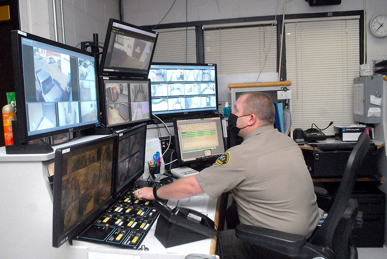 Deputy Rick Bray watches surveillance monitors from the control room at the Clallam County Jail on Wednesday in Port Angeles. (Keith Thorpe/Peninsula Daily News)
