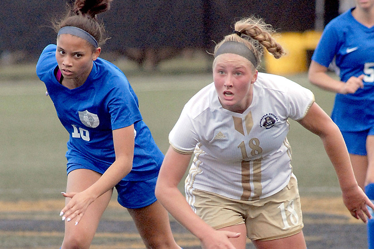 Peninsula College's Kyrsten McGuffey, right, outraces Edmonds' Kaylinn Lawrence in a march downfield on Saturday at Wally Sigmar Field in Port Angeles. (Keith Thorpe/Peninsula Daily News)