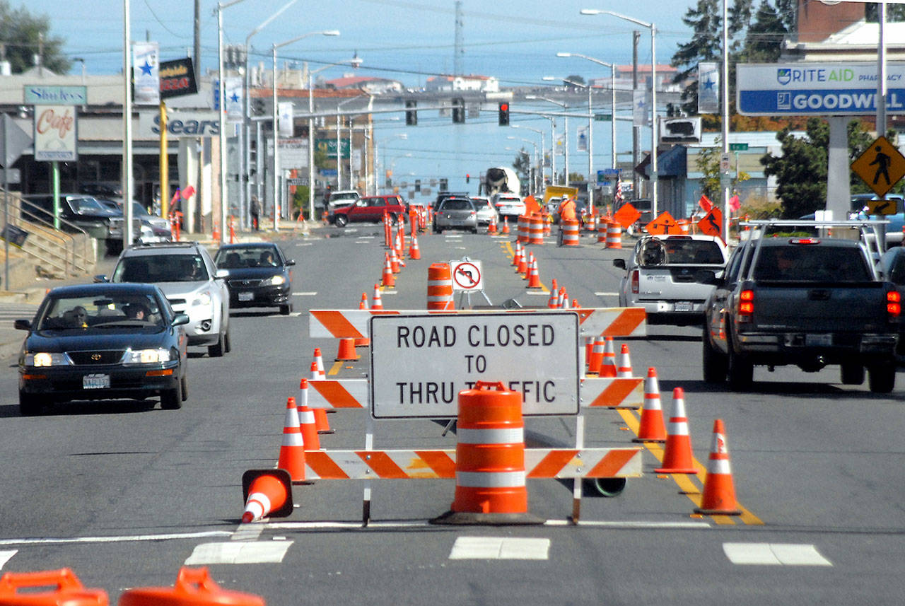 Traffic makes its way through a gauntlet of orange cones and barrels on Tuesday as part of a safety enhancement prioject on South Lincoln Street in Port Angeles. The state-funded project is intended to improve pedestrian and bicycle safety along the half-mile corridor between East First and Eighth streets. It includes upgraded pedestrian crossings and installation of a new traffic light at Third Street. The project is expected to be completed by the end of the year. (Keith Thorpe/Peninsula Daily News)