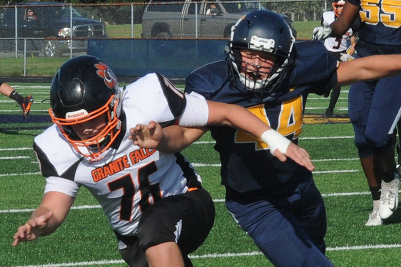 Lonnie Archibald/for Peninsula Daily News
Forks' Matthew Wallerstedt, right, tracks down the loose football after blocking a punt during a 2019 game against Granite Falls. Wallerstedt is expected to start at guard and defensive end for the Spartans this season.