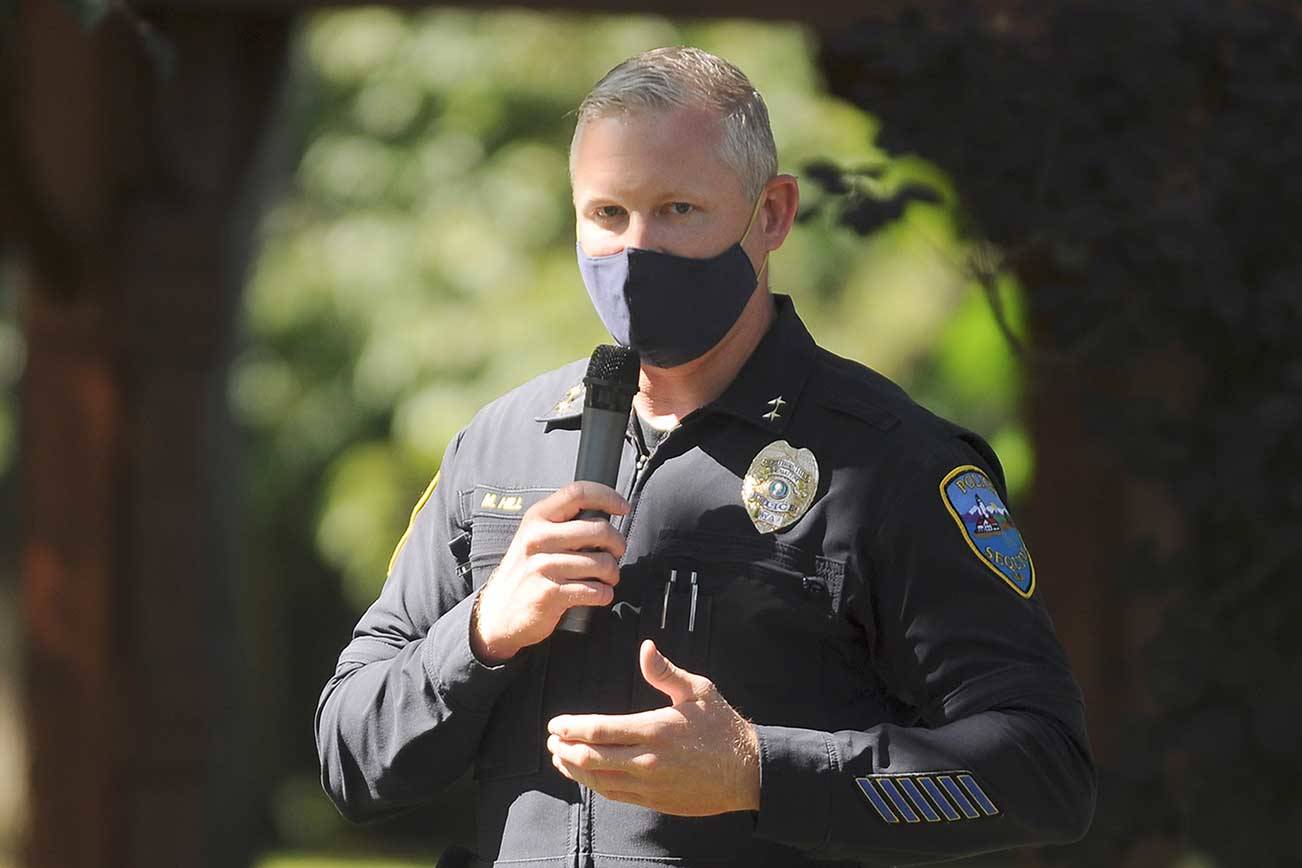 Sgt. Mike Hill of the Sequim Police Department thanks fellow essential workers at the Sequim-Dungeness Valley Chamber of Commerce's annual picnic and Citizen of the Year presentation. The chamber honored essential workers with its 2020 award. (Michael Dashiell/Olympic Peninsula News Group)