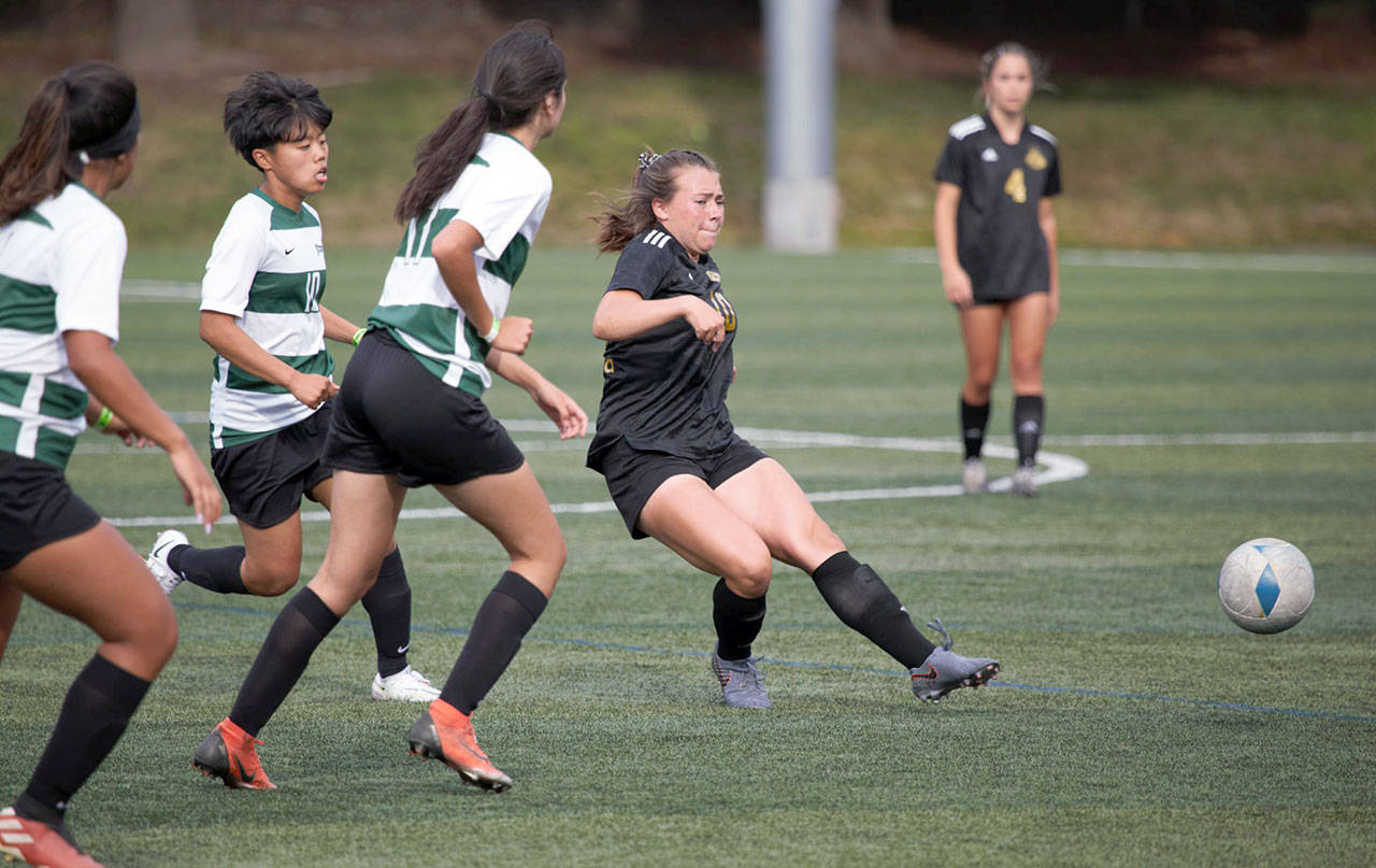 Peninsula College’s Grace Johnson distributes the ball to a teammate while chased by three Chemeketa defenders during the Pirates’ 11-0 victory Wednesday. Johnson, Chimacum High School’s all-time leading goal scorer, netted her first collegiate hat trick in the win. (Rick Ross/Peninsula College Athletics)