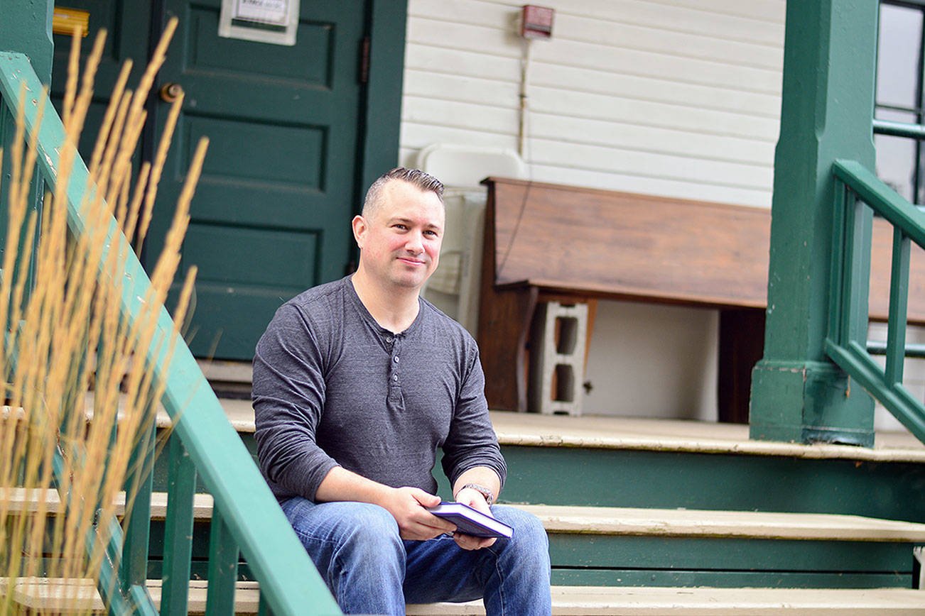 Joe Gillard of Quilcene, pictured on the steps of the Centrum building where he works, is author of “The Little Book of Lost Words.” (Diane Urbani de la Paz/Peninsula Daily News)