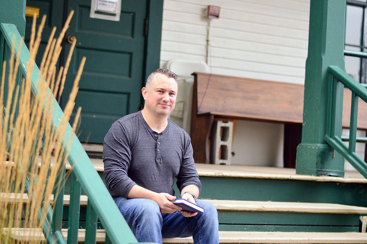 Joe Gillard of Quilcene, pictured on the steps of the Centrum building where he works, is author of “The Little Book of Lost Words.” (Diane Urbani de la Paz/Peninsula Daily News)