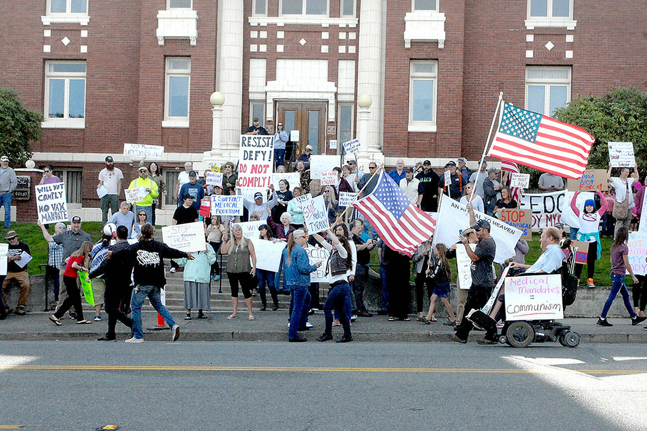 Mask mandate protesters gather in front of the Clallam County Courthouse in Port Angeles on Friday. (Keith Thorpe/Peninsula Daily News)