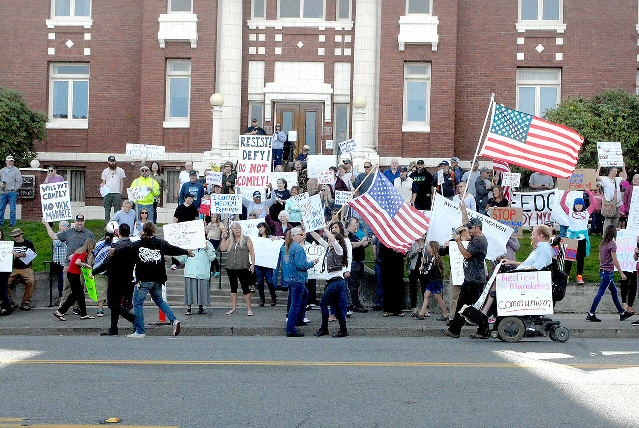 Mask mandate protesters gather in front of the Clallam County Courthouse in Port Angeles on Friday. (Keith Thorpe/Peninsula Daily News)