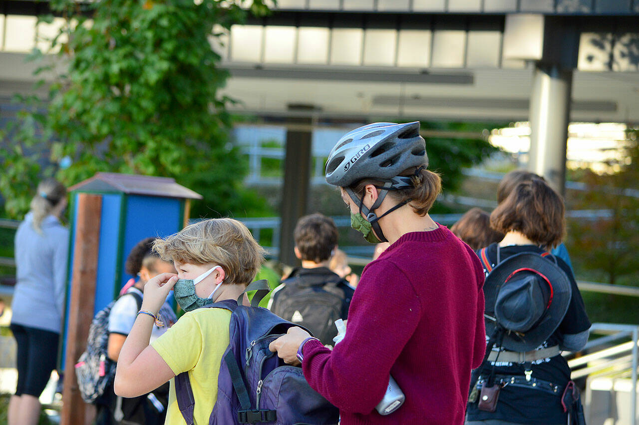 Jamie Haney helps her fourth-grader Elise prepare for the first day of school Tuesday morning at Salish Coast Elementary in Port Townsend. (Diane Urbani de la Paz/Peninsula Daily News)