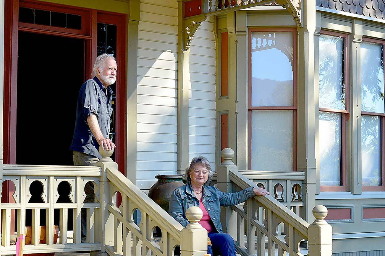 Oyster Races organizer Brian Cullin, left, and Quilcene Museum supporter Cleone Telling take in the sun on the porch of the 1892 Worthington Mansion in Quilcene. Sunday tours of the mansion are part of this weekend’s Quilcene Fair activities. (Diane Urbani de la Paz/Peninsula Daily News)