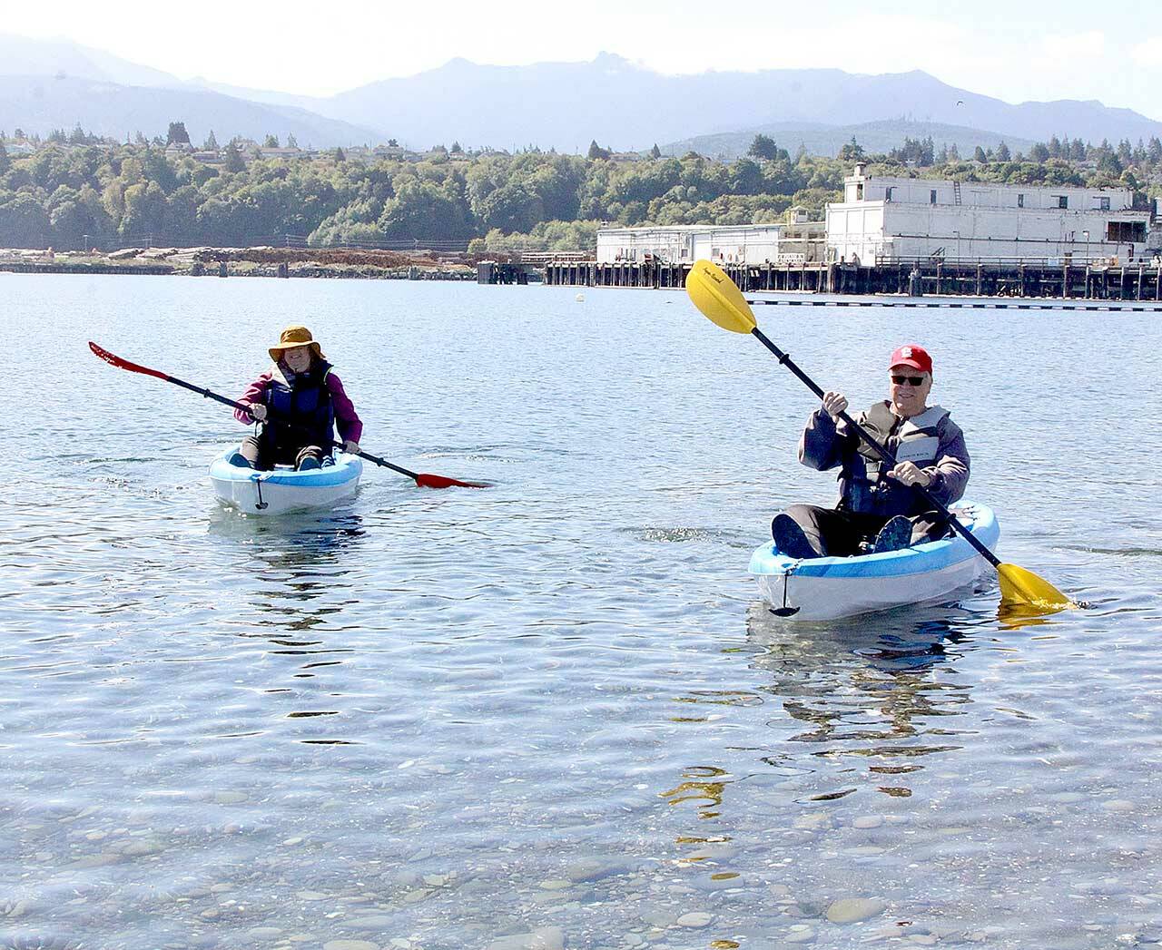 Dave Logan/For Peninsula Daily News
Sue and Tom Lotz of Port Angeles take what they call a “coffee break” in their small kayaks near Sail and Paddle Park on Ediz Hook on Thursday. They were enjoying the last days of nice weather before a predicted rain storm expected this weekend. The Lotzes said they were greeted by at least a dozen seals in the harbor on their leisurely excursion.