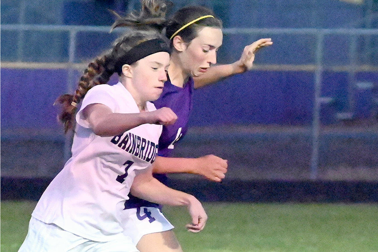 Sequim's Rileigh VanDyken, right, vies for the ball with Bainbridge's Laine Romney in the Wolves' penalty-shootout loss to the Spartans on Tuesday. (Michael Dashiell/Olympic Peninsula News Group)