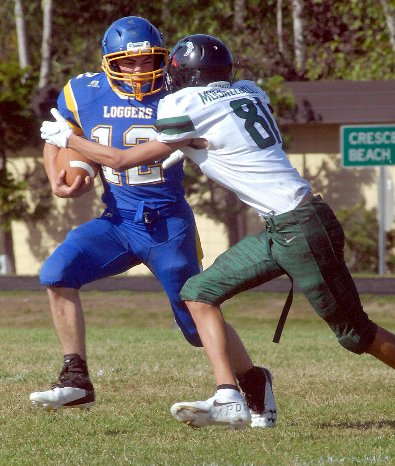 Keith Thorpe/Peninsula Daily News Crescent’s Wyatt Lee, left, fends off the defense of Muckleshoot Tribal’s Chad Millar-Moses on on Saturday in Joyce.