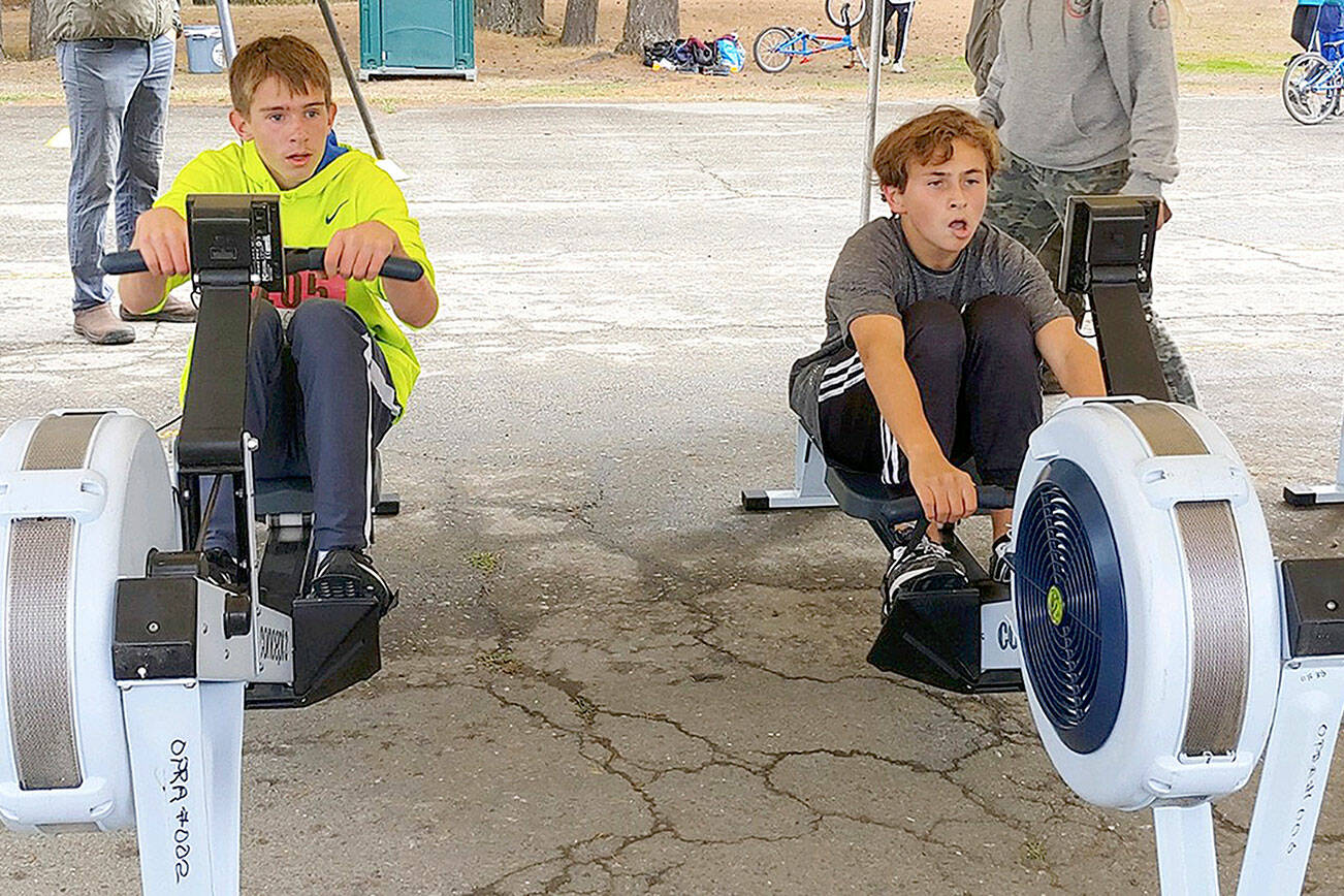 Lukas Teague of Port Angeles and Grady White of Port Townsend battle it out on the second of three events in the Little Hurt Triathlon on Sunday at Lincoln Park in Port Angeles. The events included 10 laps on the Lincoln Park BMX track, a 2,000-meter row on rowing machines, and a 1.9-mile run. Both eighth-graders led various legs of their seventh- and eighth-grade heat, with White pulling ahead on the final leg. Teague finished within a minute of the overall champion for second place. Both boys also compete for their respective middle school cross-country teams.