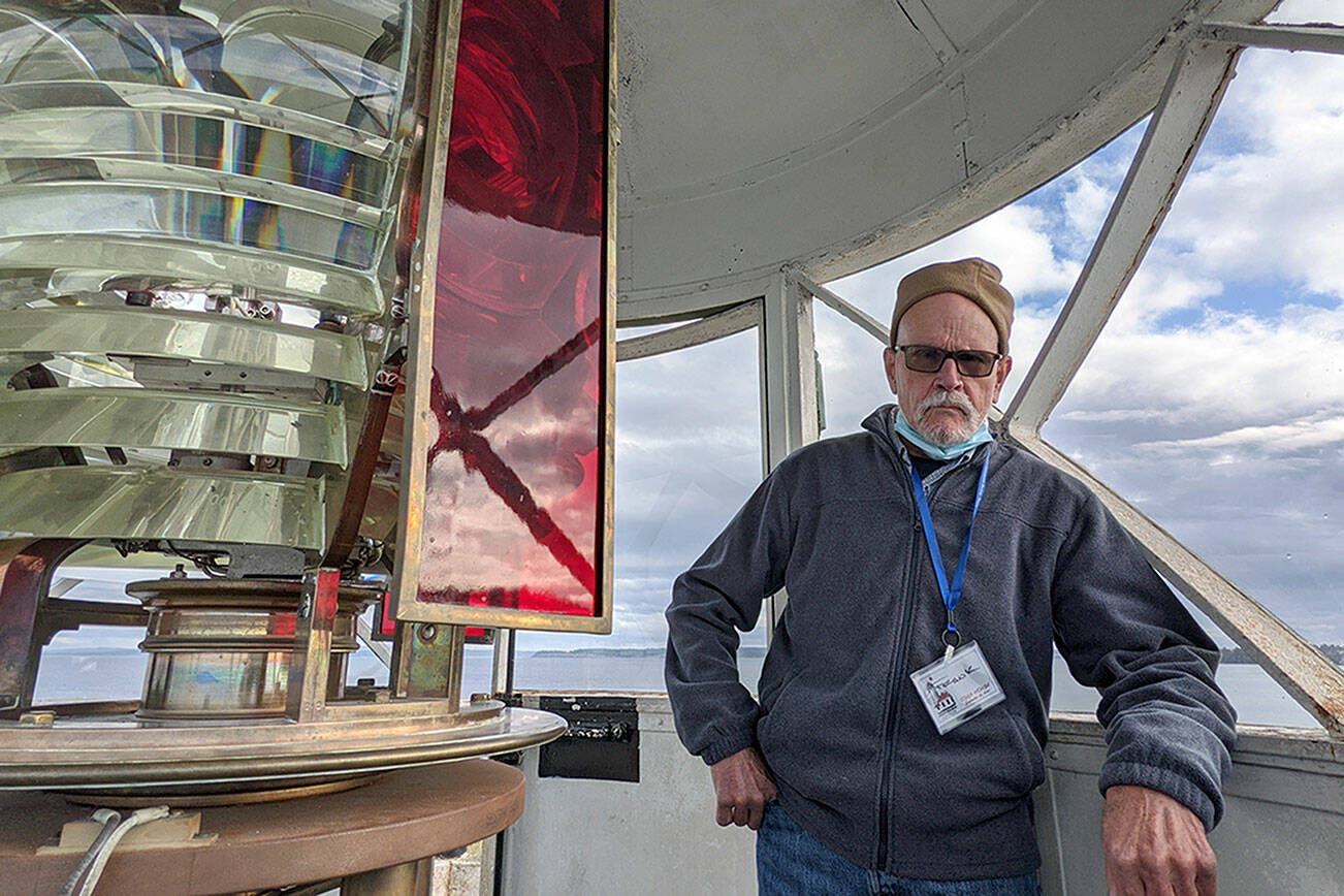 Frank Bruni, a volunteer at the Point Wilson Light Station with the U.S. Lighthouse Society, helped conduct tours of the lantern room at the top of the lighthouse on Tuesday as part of an open house of the facilities. The organization is moving into the next stage of renovations, starting with the roof of the keepers’ dwelling. (Zach Jablonski/Peninsula Daily News)