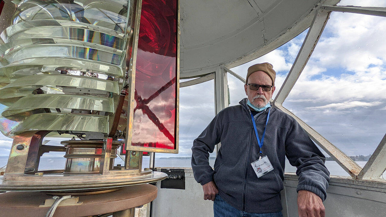 Frank Bruni, a volunteer at the Point Wilson Light Station with the U.S. Lighthouse Society, helped conduct tours of the lantern room at the top of the lighthouse on Tuesday as part of an open house of the facilities. The organization is moving into the next stage of renovations, starting with the roof of the keepers’ dwelling. (Zach Jablonski/Peninsula Daily News)