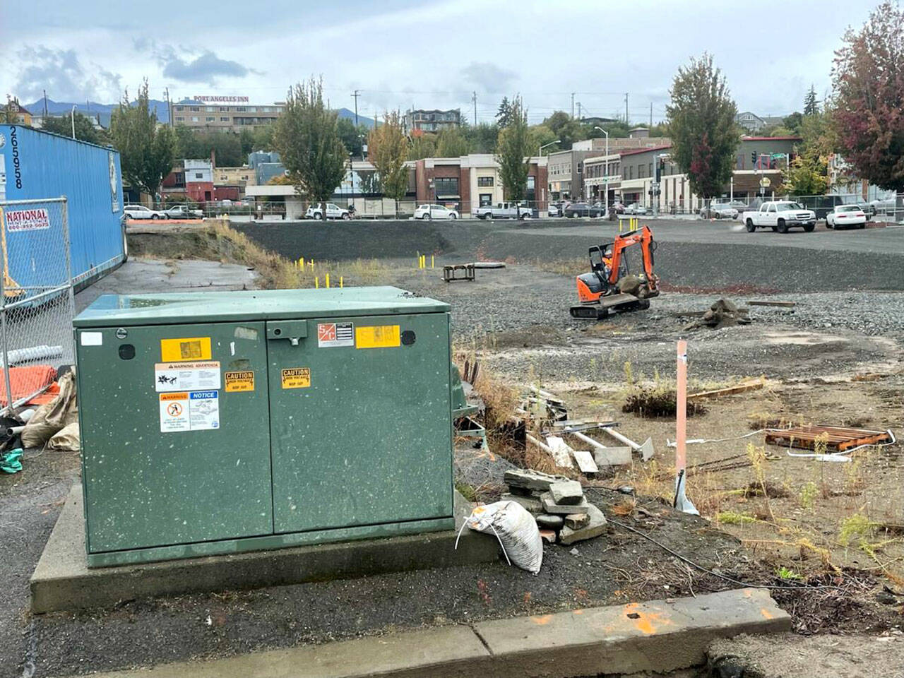 A backhoe driver works Thursday at the Elwha Hotel construction site in downtown Port Angeles while awaiting removal of an electrical switch box, foreground. (Paul Gottlieb/Peninsula Daily News)