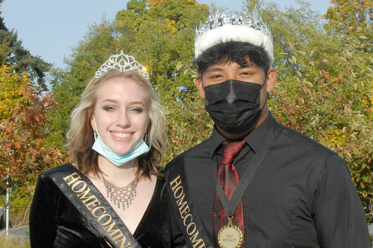 Port Angeles High School’s Samantha Robbins and Lance Menes stand together as homecoming senior queen and king before the school’s homecoming parade on Friday. The pair presided over festivities at the Roughriders’ football game on Friday night against the Kennedy Catholic Lancers. (Keith Thorpe/Peninsula Daily News)