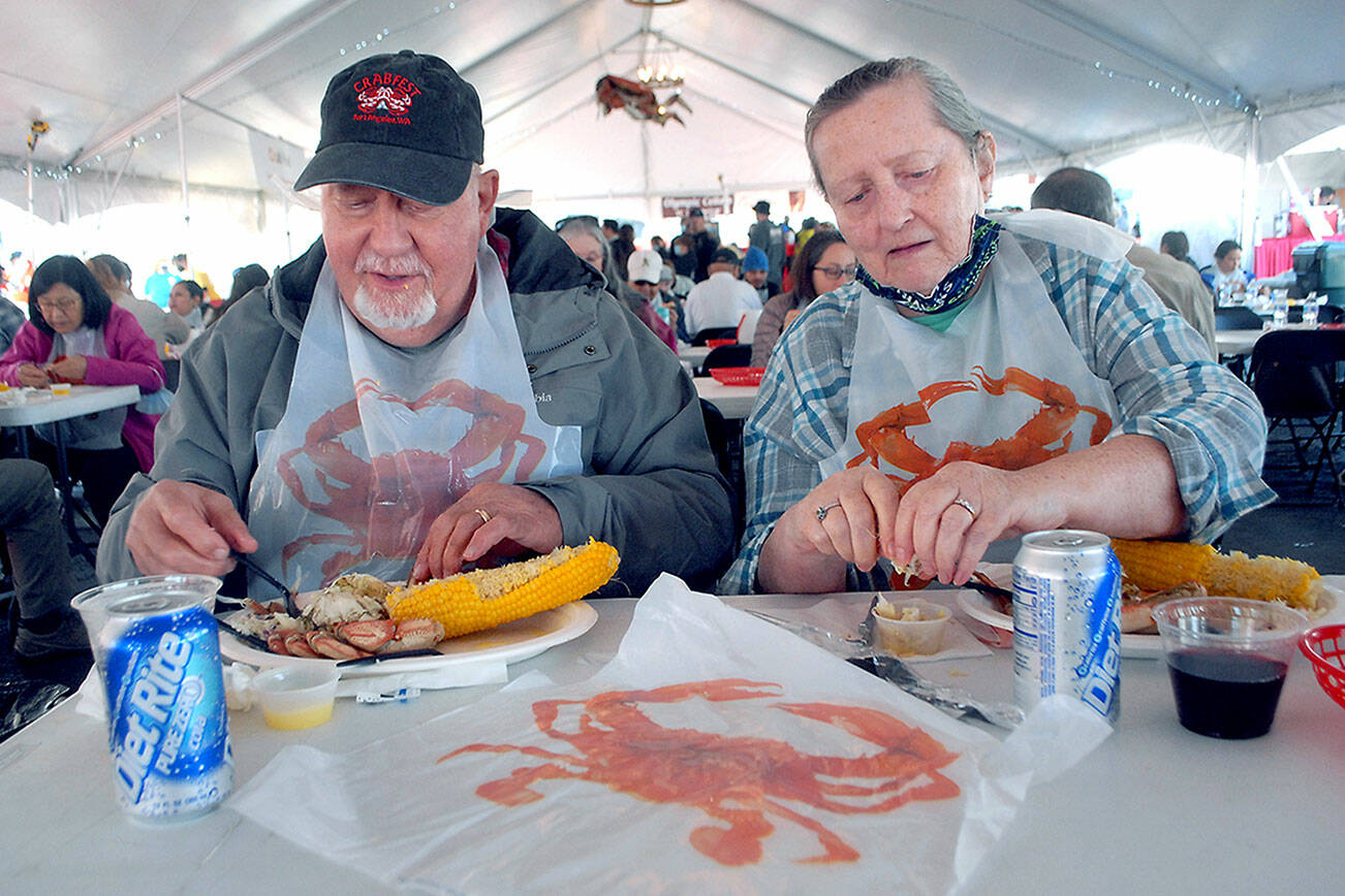 Keith Thorpe/Peninsula Daily News
Larry and Kathi Hayden of Port Angeles enjoy crab dinners on Friday at the Dungeness Crab and Seafood Festival in Port Angeles.
