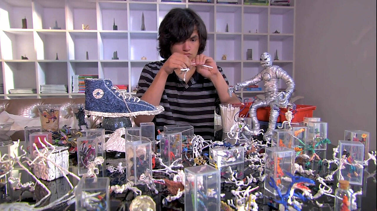 Brian Tolley works surrounded by his art created from twist-ties in “Mr. Twister,” a film about a teen with autism who wanted to combat how people were treating him differently from others. Screenshot courtesy of Sproutflix
