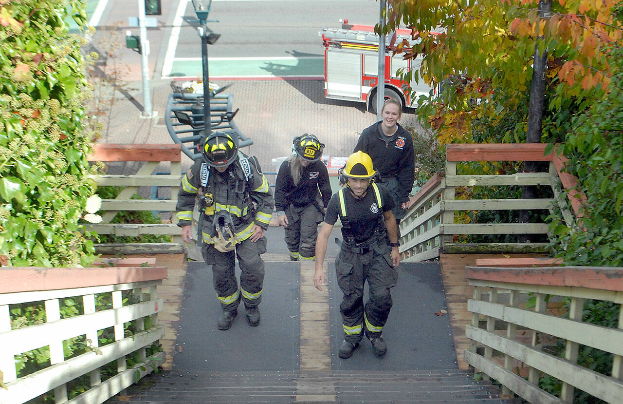 Stairclimbers, from left, Tim Davis, Margie Brueckner, Matt Aston and Esther McKellar of the Port Angeles Fire Department, practice ascending the Laurel Street Stairs above downtown Port Angeles on Saturday in preparation for next spring’s 31st annual LLS Firefighter Stairclimb on March 13 at the Columbia Center in downtown Seattle. The climb, a benefit for the Leukemia & Lymphoma Society, requires firefighters and emergency personnel to make a timed ascent of the 788-foot skyscraper’s 69 flights of stairs to help fund cancer research. (Keith Thorpe/Peninsula Daily News)