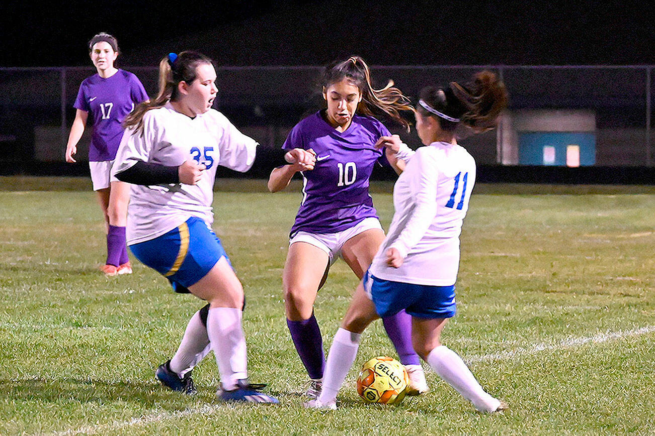 Michael Dashiell/Olympic Peninsula News Group
With teammate Kaia Lestage (left) looking on, Sequim's Jennyfer Gomez (10) vies for possession in the Wolves' 6-0 win Tuesday night against visiting Bremerton.